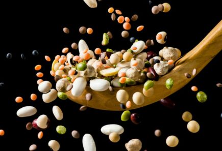 Legumes flying around wooden spoon