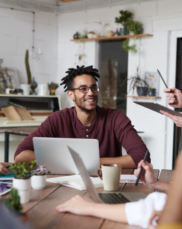 Photo of a group of people meeting using laptops and tablets