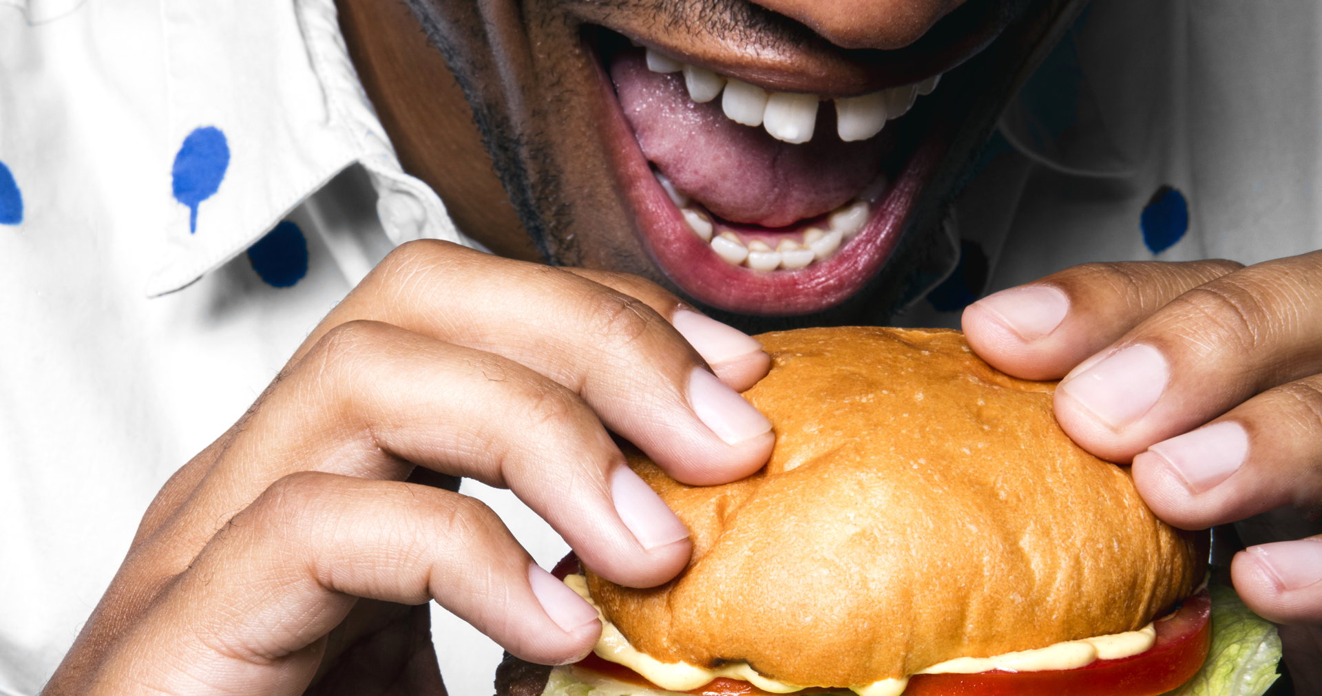 Impossible foods enters retail as demand for refrigerated plant-based burgers skyrockets, entry to accelerate plant-based meat market growth 1 Person taking a bite of a burger