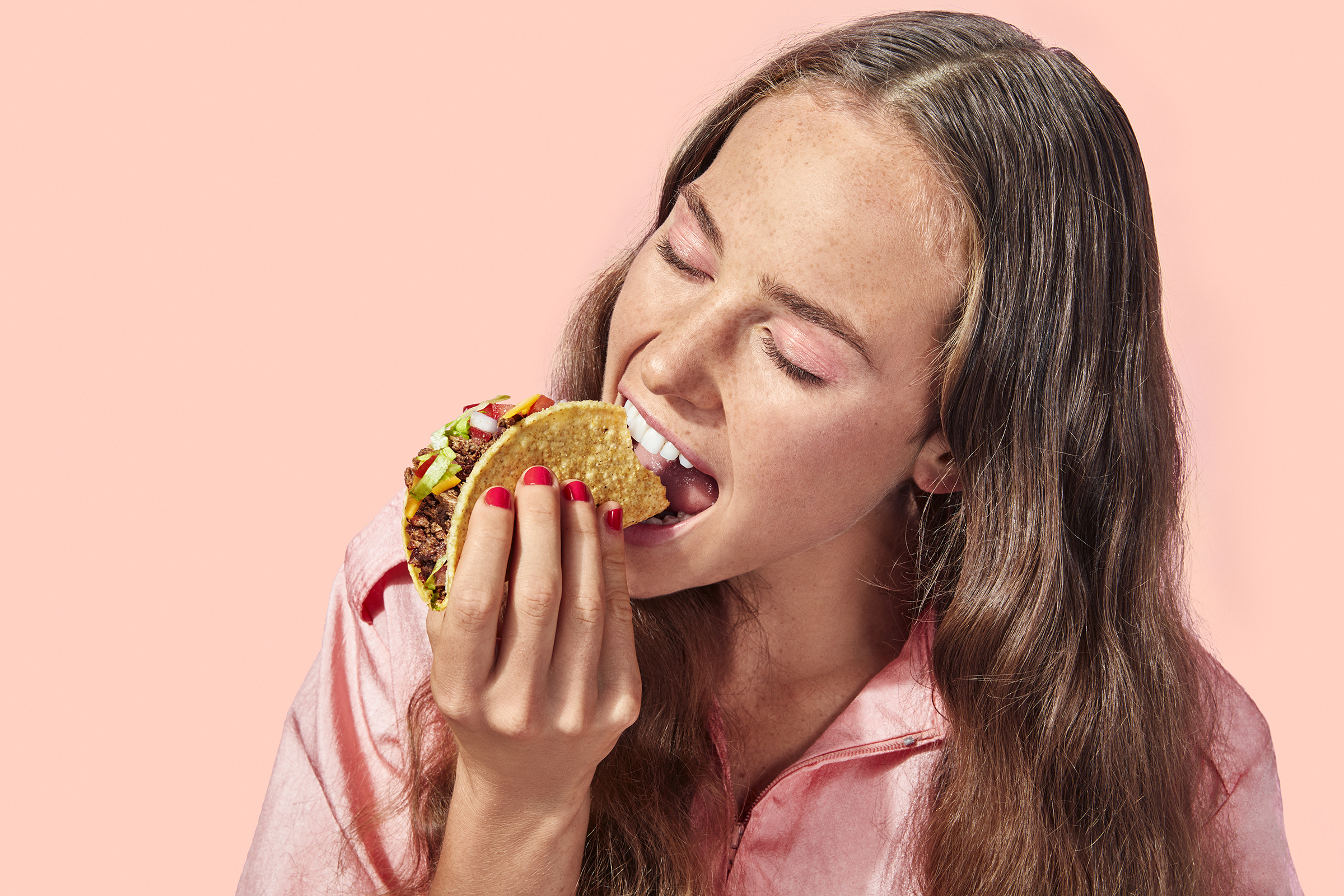 America's biggest restaurant chains scored on their plant-based offerings 1 Person taking a bite of a taco