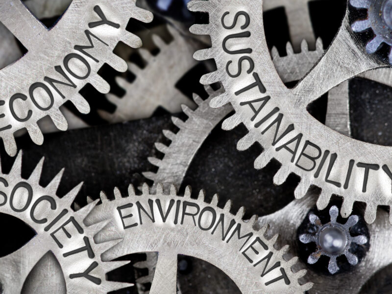 Gears labeled with economy, sustainability, society, environment