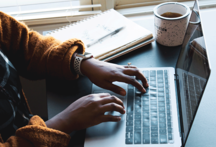 person typing on laptop