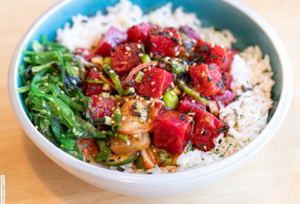 A bowl of plant-based salmon on a bed of rice