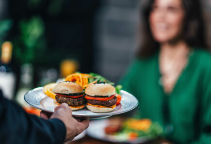 A close up view of two plant-based burger patties on a serving platter