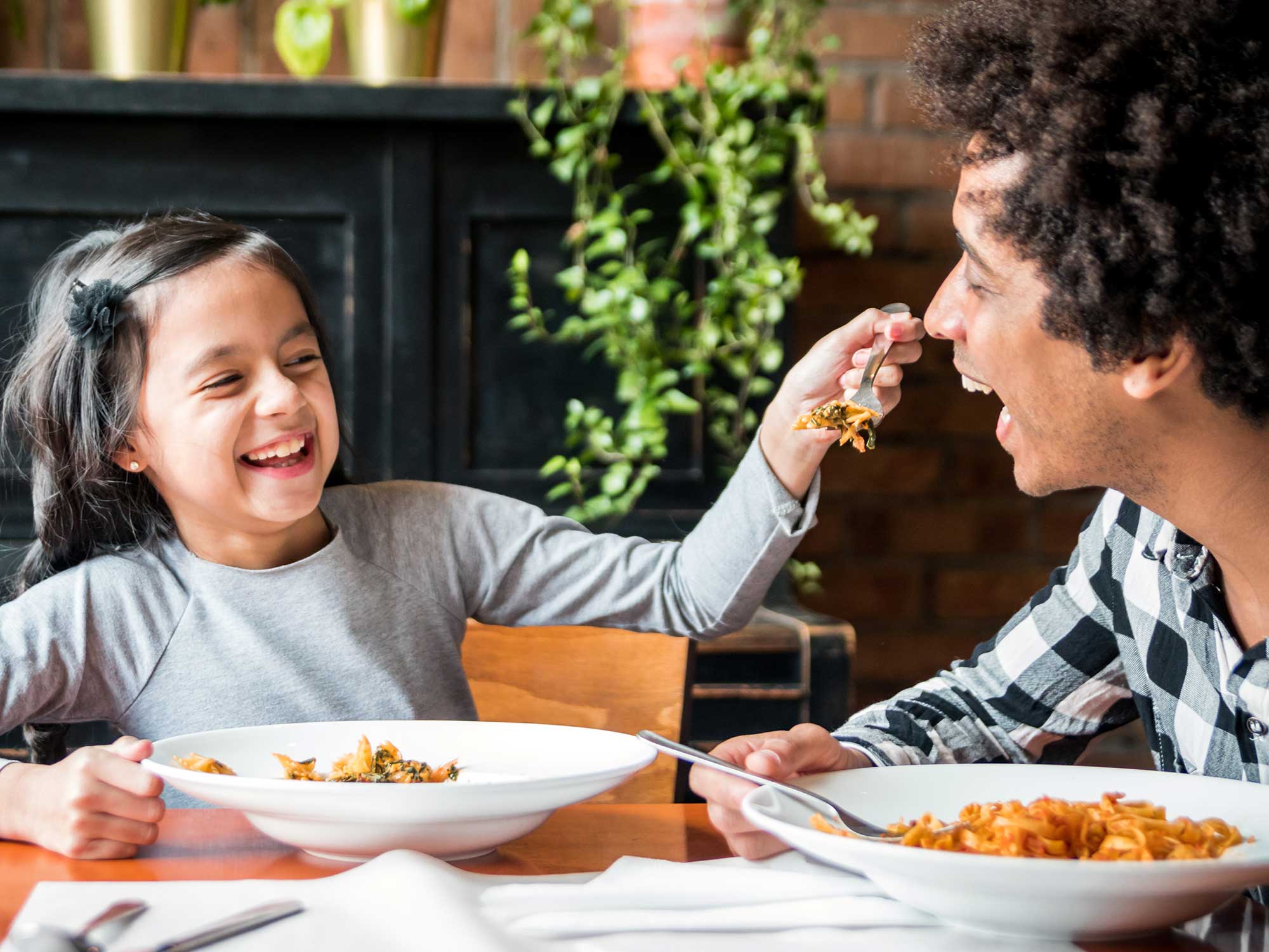 A family sits at a table eating dinner